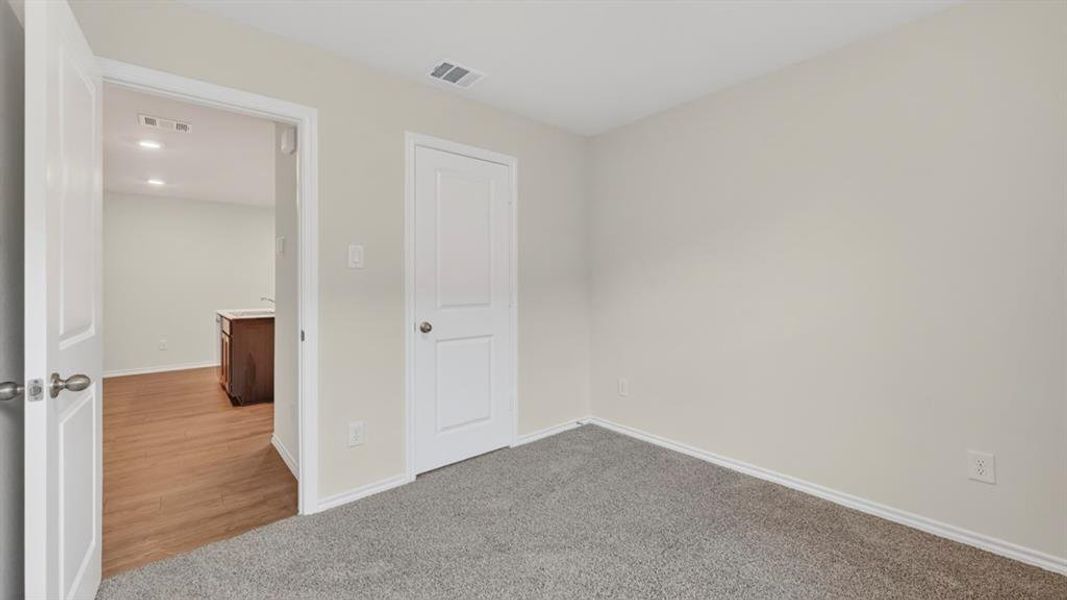 Bedroom featuring grey carpet flooring and light-toned walls