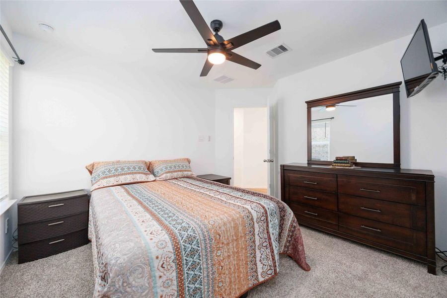 Secondary Bedroom:Comfortable and well-sized with plush carpet, ceiling fan, and flexible space for guests or a home office. Secondary Bedroom:Comfortable and well-sized with plush carpet, ceiling fan, and flexible space for guests or a home office.