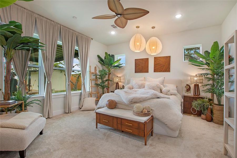 Bedroom featuring light colored carpet, ceiling fan, and recessed lighting Bedroom featuring light colored carpet, ceiling fan, and recessed lighting
