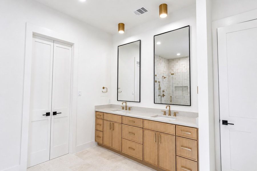 Dual vanities with quartz countertops enchance the primary bathroom Dual vanities with quartz countertops enchance the primary bathroom