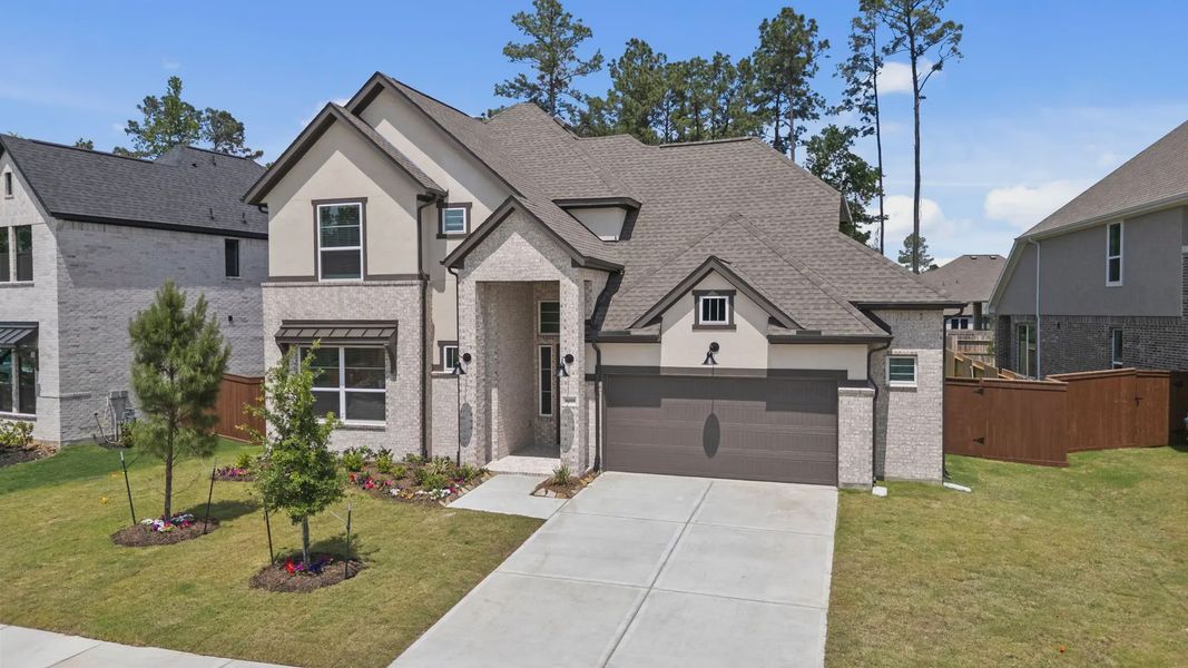 Front exterior of a new home in Evergreen 60s, Conroe, TX, highlighting curb appeal (Image 26).