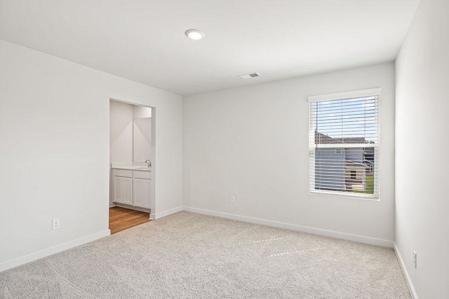 A room with a window and a carpet.