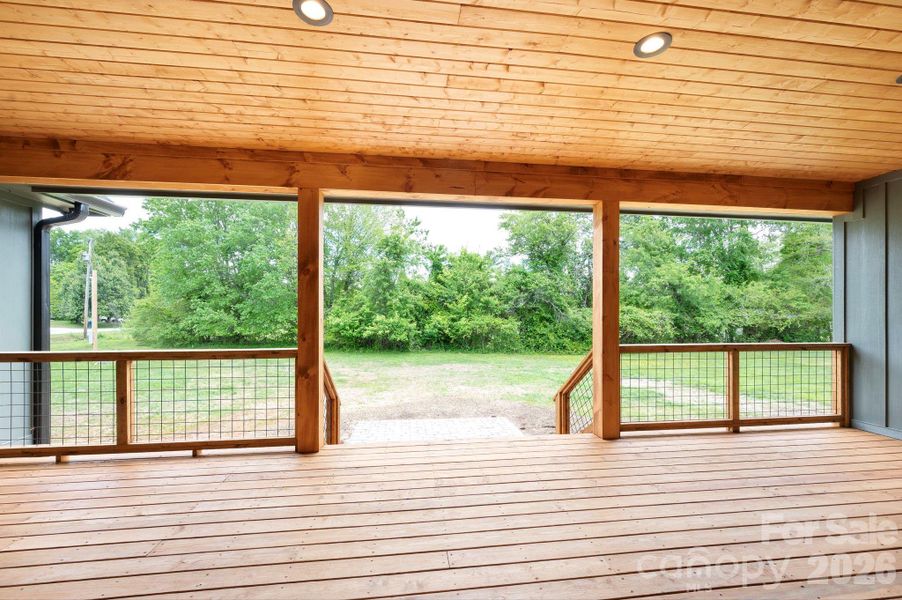 Covered back deck leads to patio for extended outdoor space