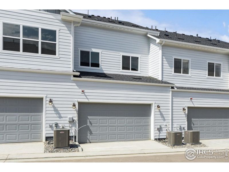 Front exterior of a new home in Kinston Mainstreet Townhomes, Loveland, CO, highlighting curb appeal (Image 25). Front exterior of a new home in Kinston Mainstreet Townhomes, Loveland, CO, highlighting curb appeal (Image 25).