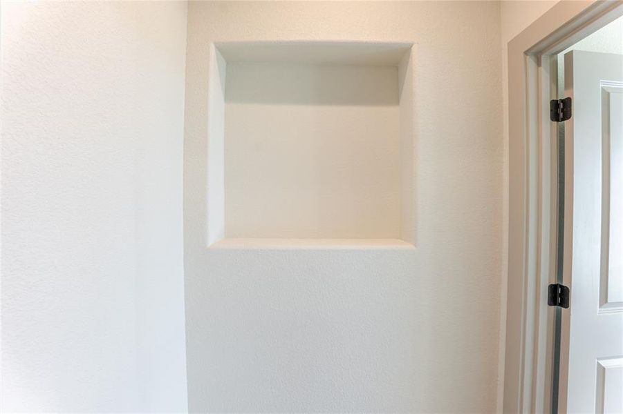 Hallway to the Primary Suite, this niche' adds a decorative element and sits between two walk-in pantry's. Hallway to the Primary Suite, this niche' adds a decorative element and sits between two walk-in pantry's.