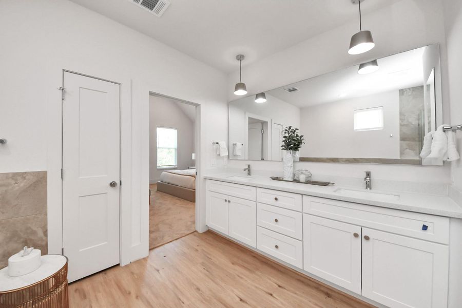 The primary bathroom features a sleek double vanity for added convenience. The primary bathroom features a sleek double vanity for added convenience.