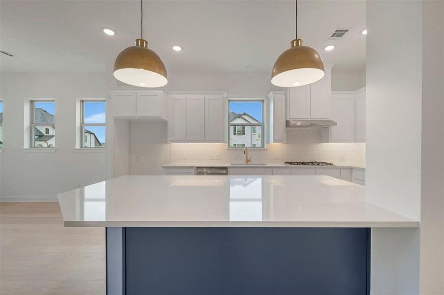 Kitchen island featuring a white countertop and a dark blue base