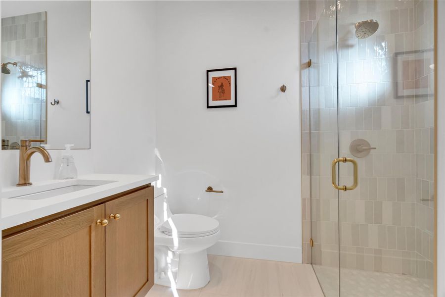 Bathroom featuring vanity and a shower stall Bathroom featuring vanity and a shower stall