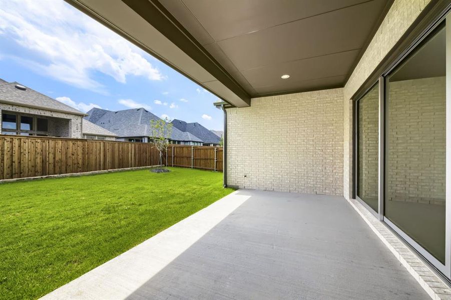 Covered patio with light brick exterior wall and recessed lighting Covered patio with light brick exterior wall and recessed lighting
