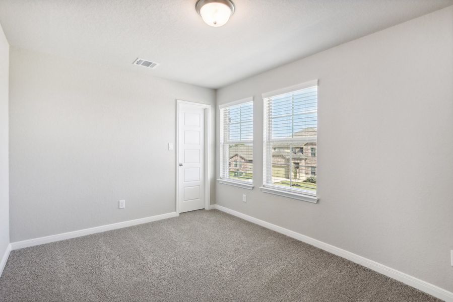 Guest bedroom in the Medina floorplan at a Meritage Homes community.