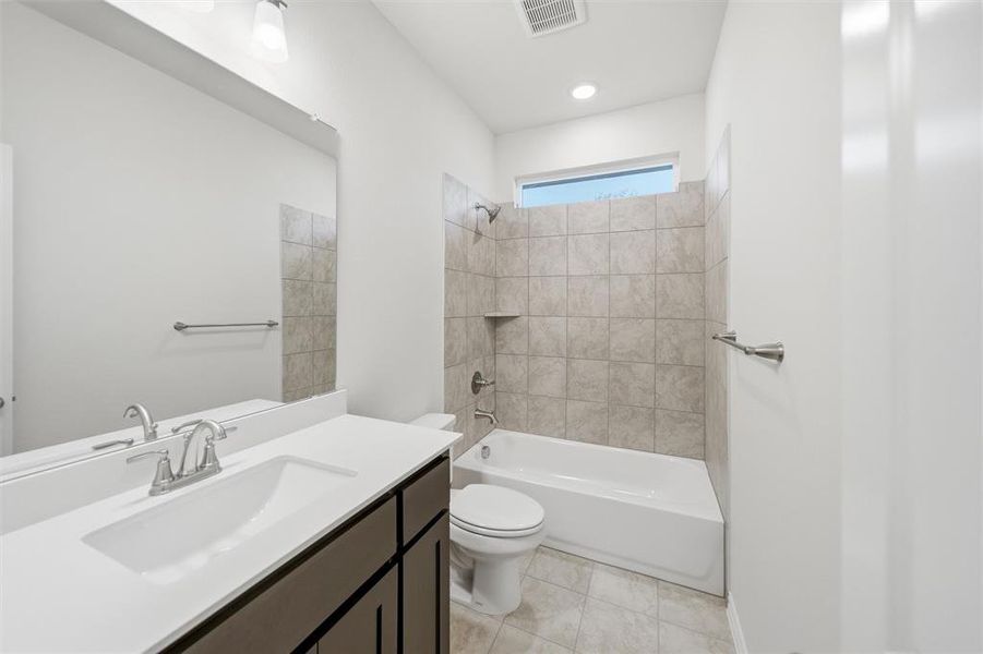 Full bathroom with shower / bathtub combination, vanity, and light tile patterned floors