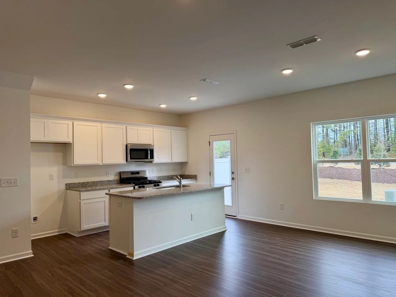 Kitchen - Chic white finishes and smooth surfaces shine.