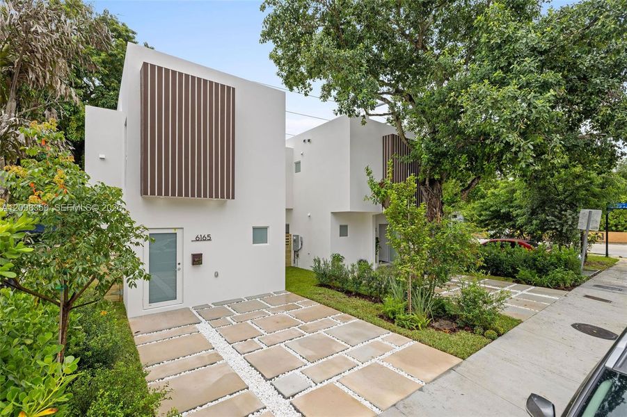 Front exterior of a new home in , South Miami, FL, highlighting curb appeal (Image 19). Front exterior of a new home in , South Miami, FL, highlighting curb appeal (Image 19).