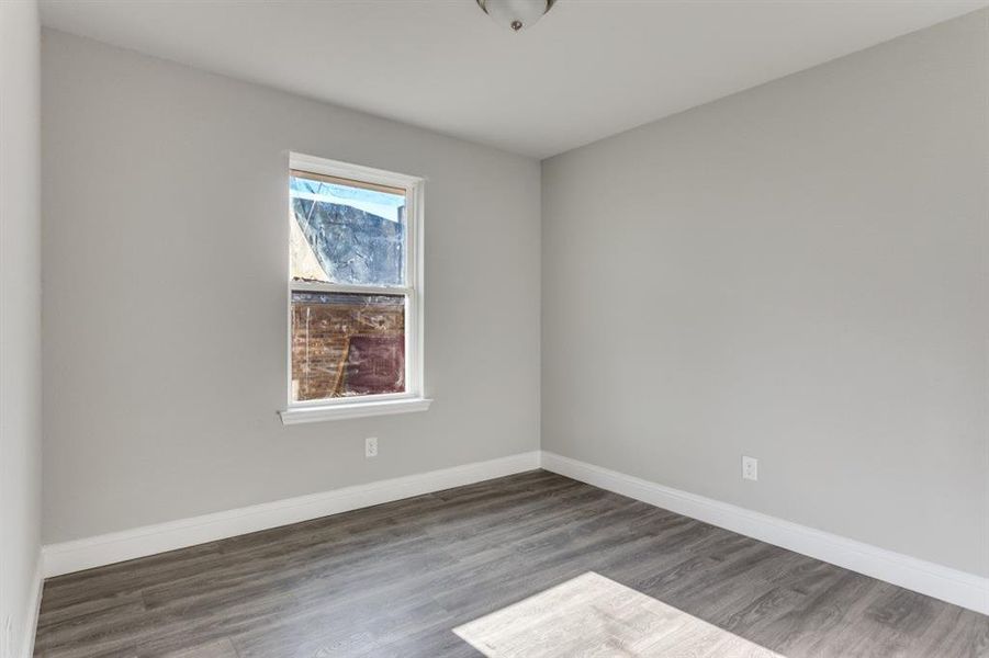Empty room featuring baseboards and wood finished floors