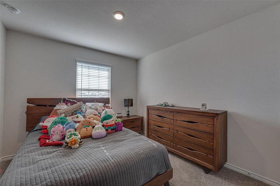 Carpeted bedroom featuring baseboards