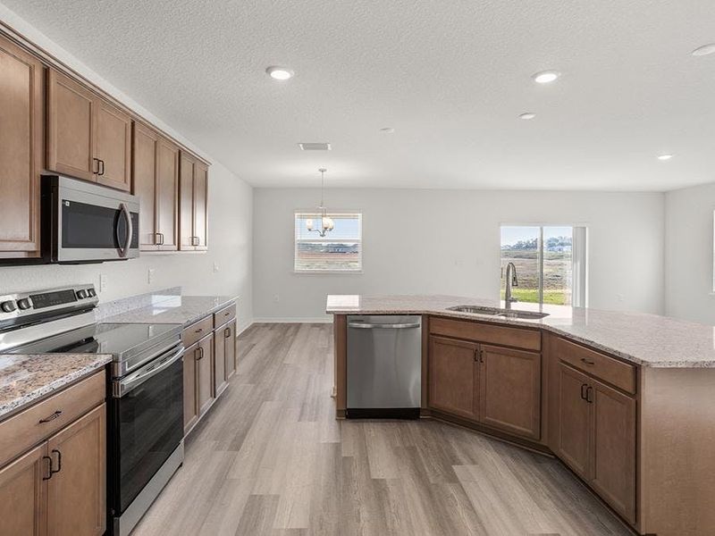 The well-appointed kitchen includes granite, 36-inch cabinets, Samsung appliances, and a walk-on pantry.