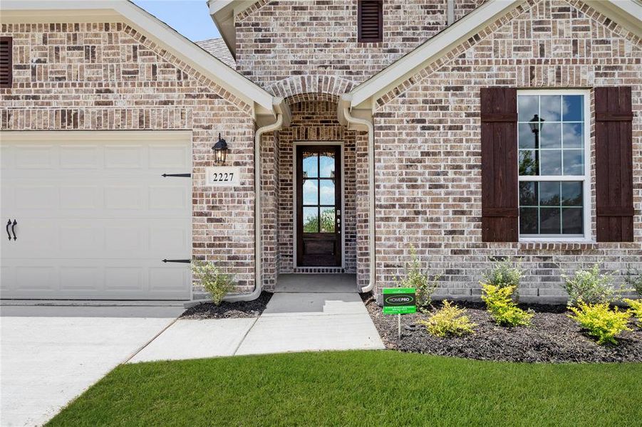Exterior details and patio area of a home in Walden Pond, Forney (Image 26).