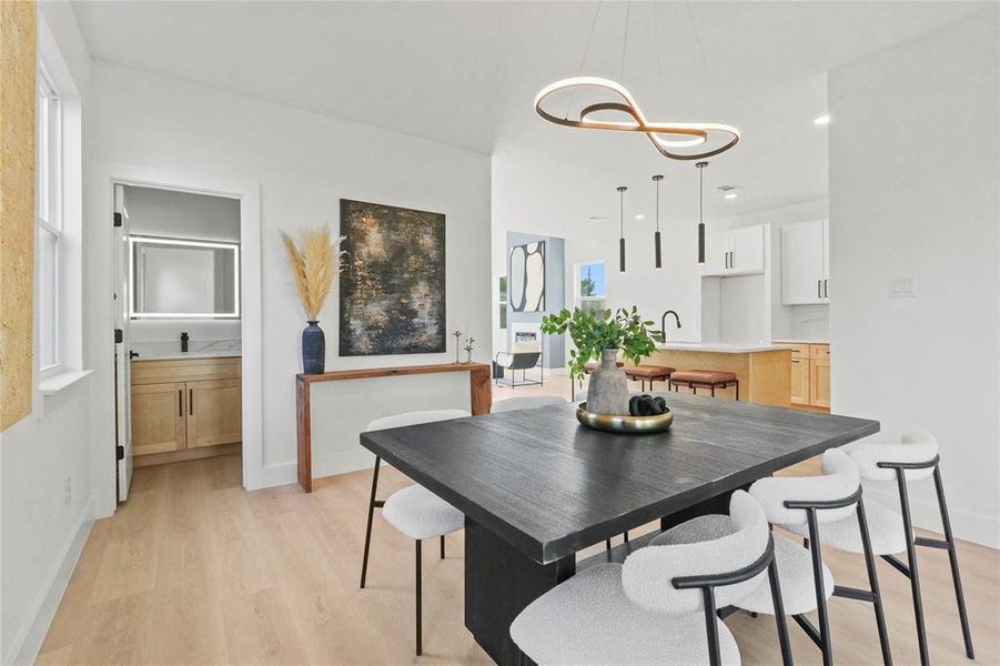 Dining space with light wood-type flooring and recessed lighting Dining space with light wood-type flooring and recessed lighting
