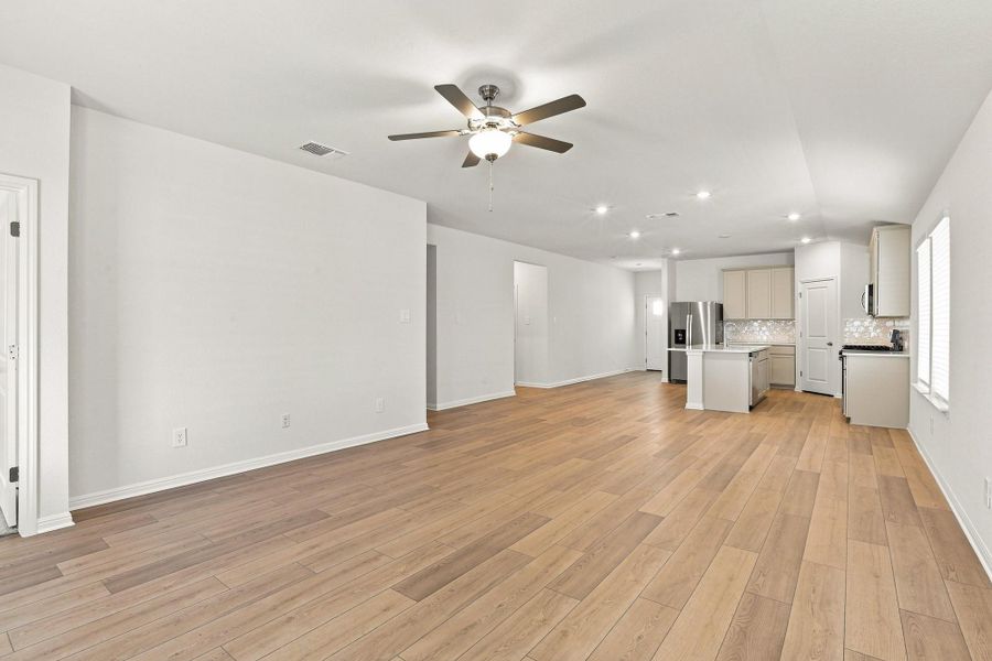 A seamless open layout connects the spacious main living area to the kitchen.