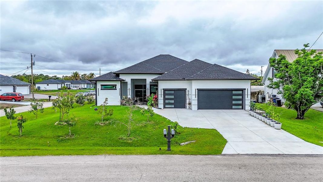Front exterior of a new home in , Lehigh Acres, FL, highlighting curb appeal (Image 32).