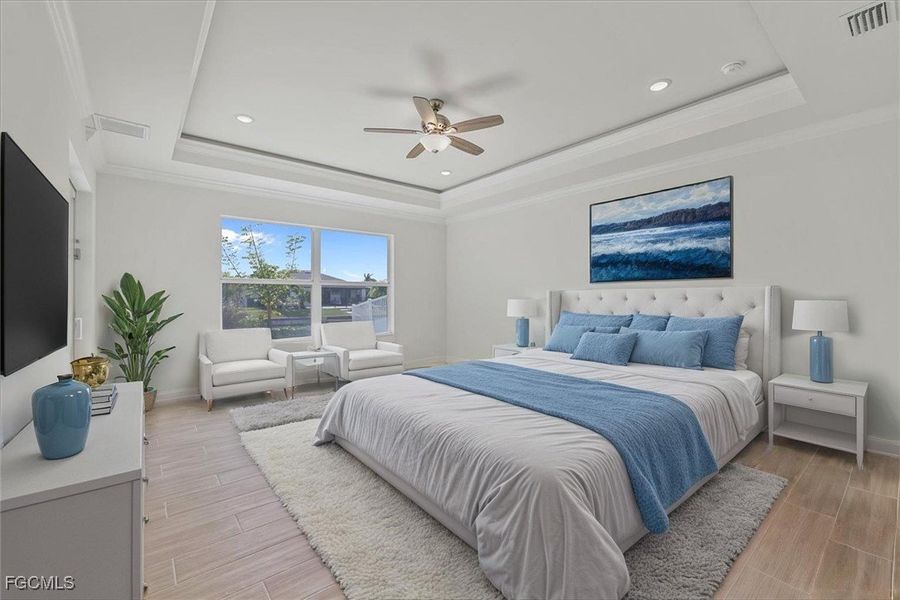 Bedroom featuring crown molding, wood tiled floors, a raised ceiling, a ceiling fan, and recessed lighting