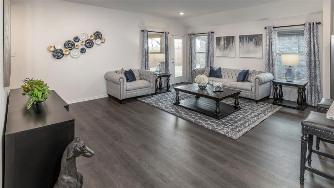 Living area with vaulted ceiling, recessed lighting, and dark wood-type flooring