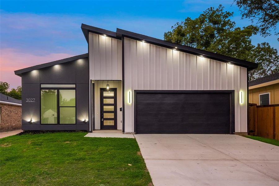 Contemporary home with a yard and a garage