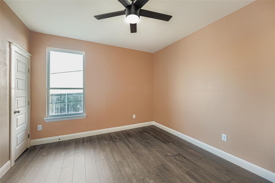 Unfurnished room featuring hardwood / wood-style flooring and a ceiling fan