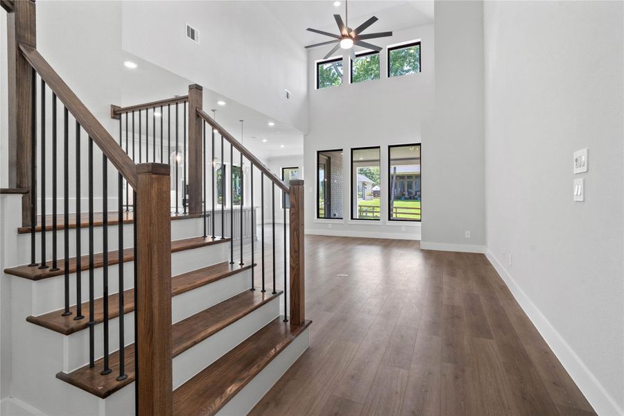 Enjoy an open, airy living experience with a wall of windows that flood the Great Room with abundant light and clear views of the rear covered patio and backyard space.