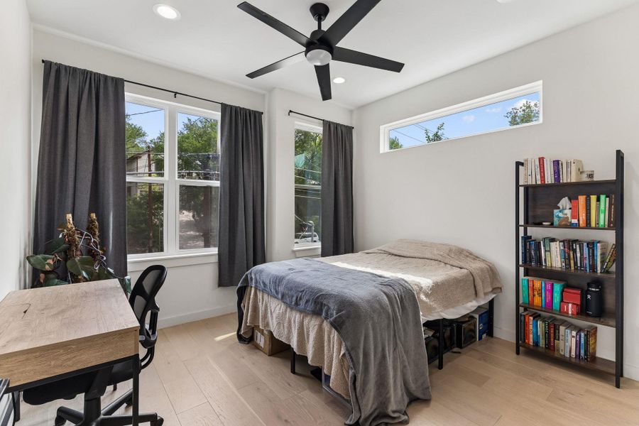 Light wood-finish flooring complements the white walls and ceiling