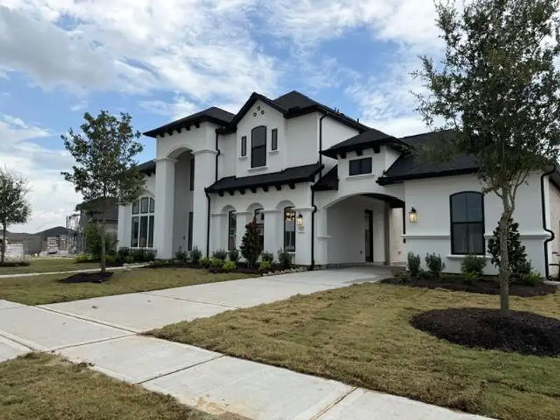 Front exterior of a new home in Dunham Pointe, Cypress, TX, highlighting curb appeal (Image 2). Front exterior of a new home in Dunham Pointe, Cypress, TX, highlighting curb appeal (Image 2).