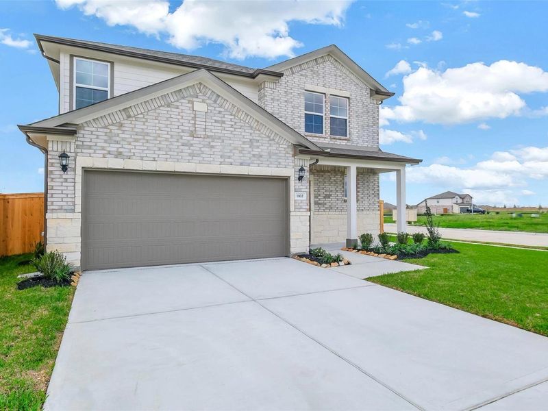 Front exterior of a new home in Emberly, Beasley, TX, highlighting curb appeal (Image 21).