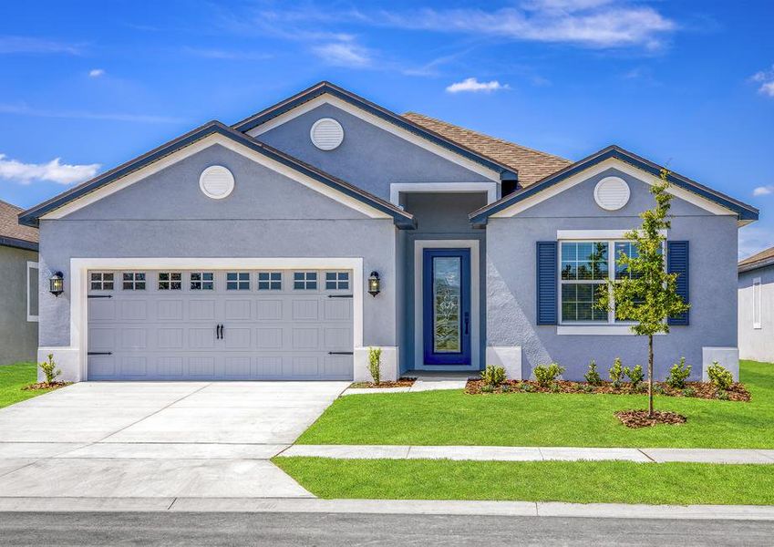 The exterior of the Camellia with blue stucco and white trim details