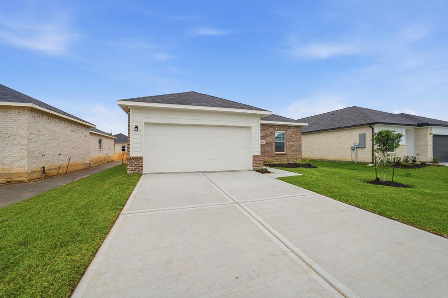 Front exterior of a new home in Steed Landing, Texas City, TX, highlighting curb appeal (Image 2). Front exterior of a new home in Steed Landing, Texas City, TX, highlighting curb appeal (Image 2).