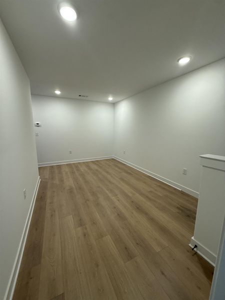 Spare room with light wood-style floors and recessed lighting