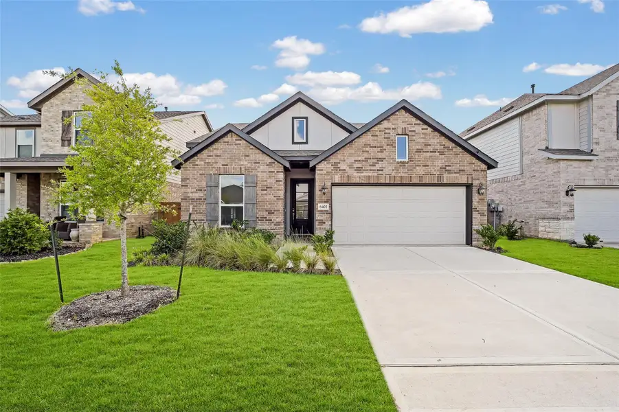 Front exterior of a new home in Sunterra, Katy, TX, highlighting curb appeal (Image 1). Front exterior of a new home in Sunterra, Katy, TX, highlighting curb appeal (Image 1).