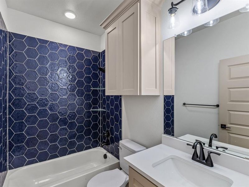 Bathroom with vanity, toilet, and shower / bathtub combination