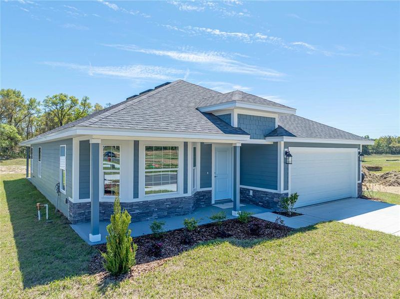 Front exterior of a new home in Briarwood, Alachua, FL, highlighting curb appeal (Image 24).