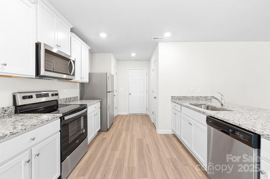 Furnished interior view inside a new home in McKee Creek Village, Charlotte (Image 6). Furnished interior view inside a new home in McKee Creek Village, Charlotte (Image 6).