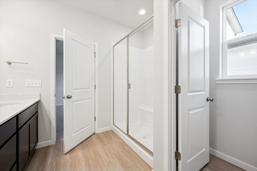 A room with a glass shower.