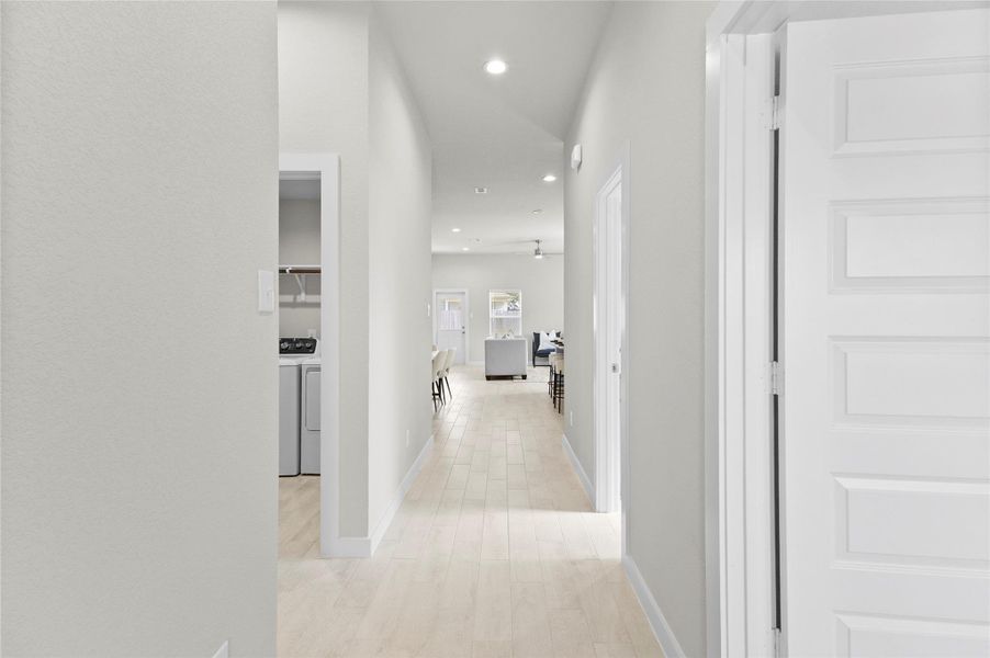 Your Bright entry hallway features recessed lighting, light-toned flooring, and an open sightline toward the main living area, with the laundry space nearby. Your Bright entry hallway features recessed lighting, light-toned flooring, and an open sightline toward the main living area, with the laundry space nearby.