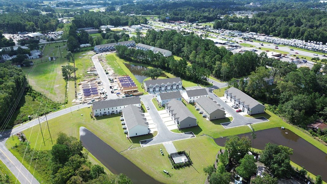 Aerial view of the The Townes at Amber Bluff community in Conway, SC, showing layout and nearby surroundings (Image 1).
