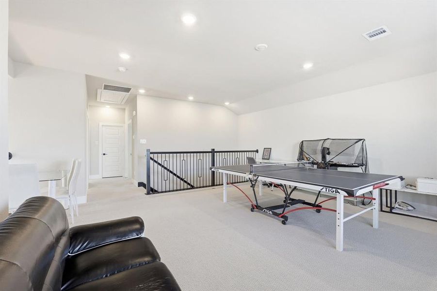 Game room featuring recessed lighting, light carpet, and vaulted ceiling