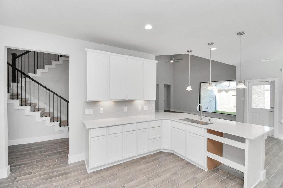 All of this overlooks your expansive family room, creating a perfect space for culinary delights and family gatherings.