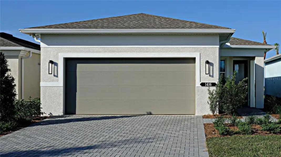 Front exterior of a new home in Cresswind at Lake Harris, Tavares, FL, highlighting curb appeal (Image 2). Front exterior of a new home in Cresswind at Lake Harris, Tavares, FL, highlighting curb appeal (Image 2).