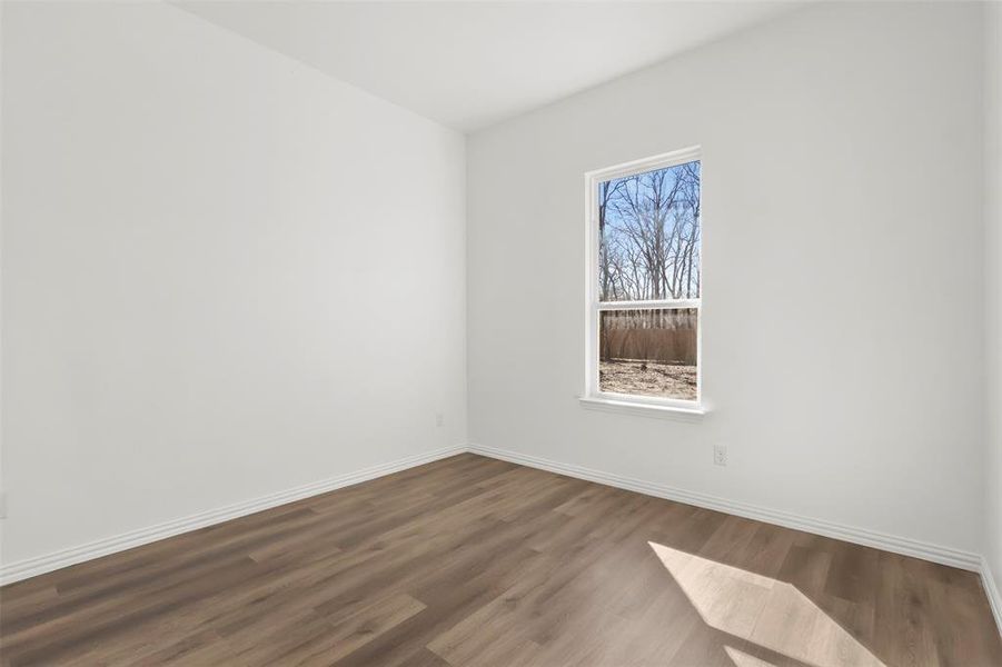 Spare room featuring dark hardwood / wood-style floors