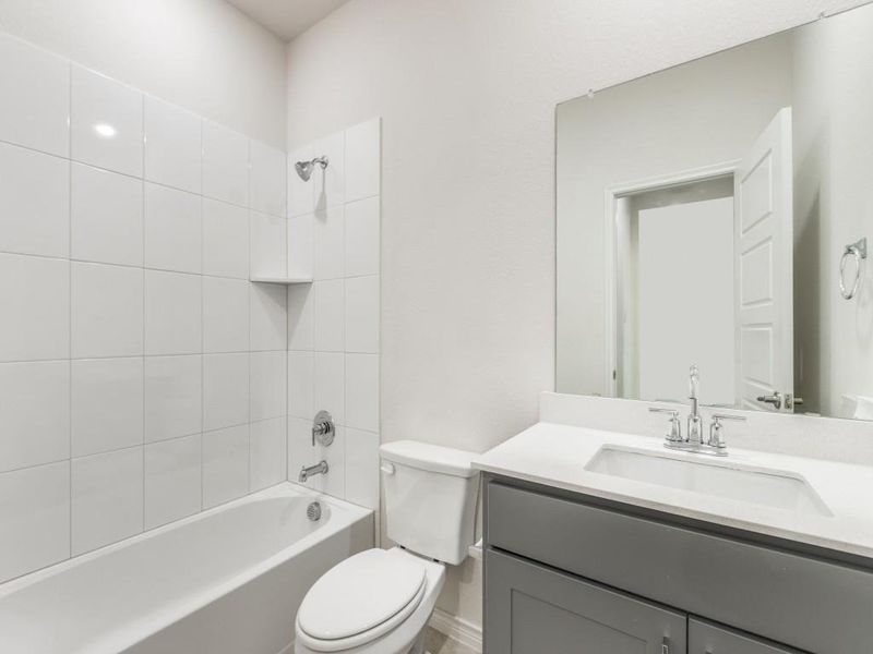 Bathroom featuring bathtub / shower combination and vanity
