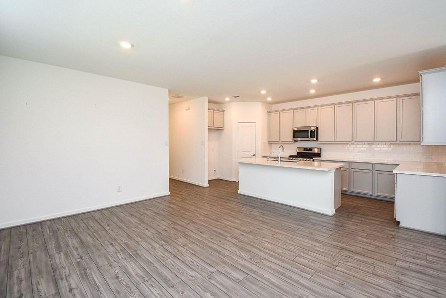 DINING AREA OPEN TO DEN/FAMILY ROOM AREA