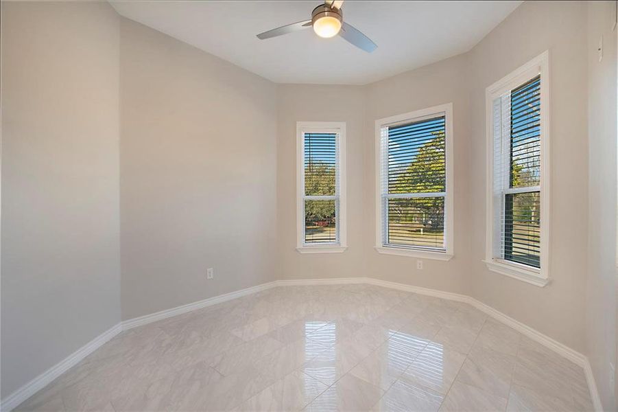 Spare room with baseboards and a ceiling fan Spare room with baseboards and a ceiling fan