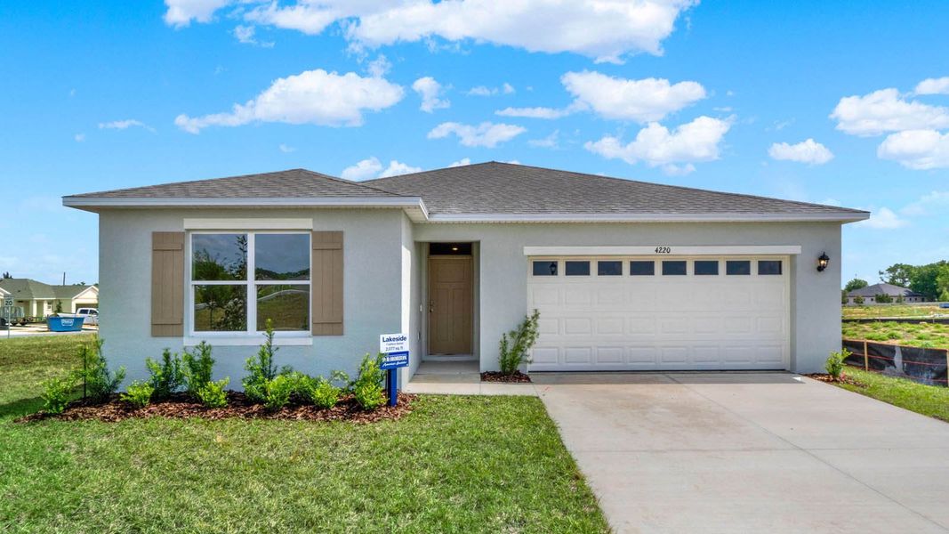 Front exterior of a new home in Ironwood, Daytona Beach, FL, highlighting curb appeal (Image 1). Front exterior of a new home in Ironwood, Daytona Beach, FL, highlighting curb appeal (Image 1).